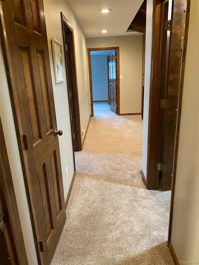 hallway featuring light carpet