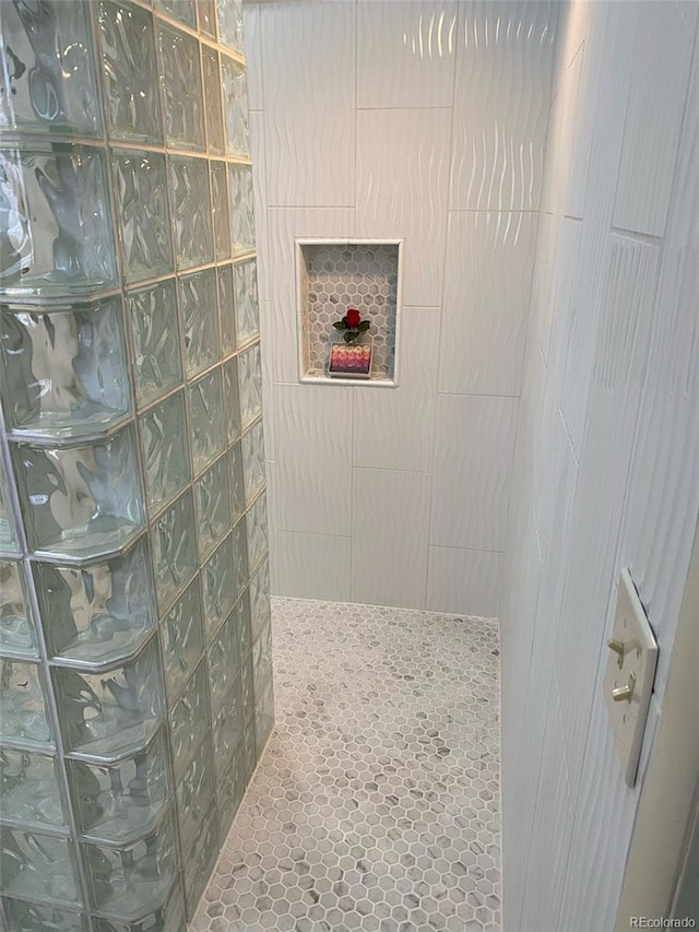 bathroom with tiled shower