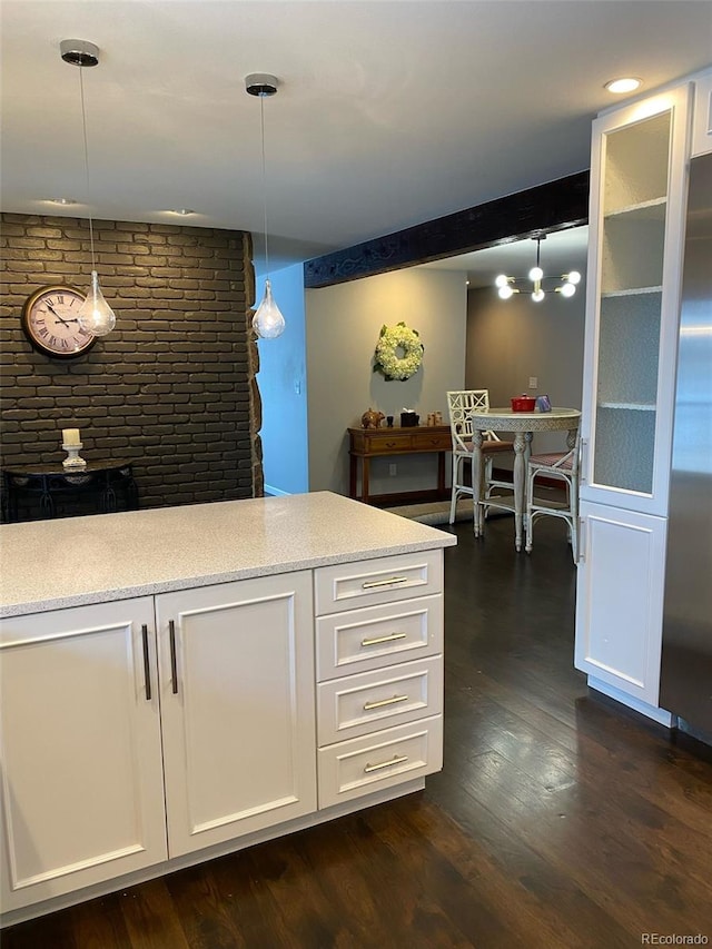 kitchen featuring decorative light fixtures, dark hardwood / wood-style floors, and white cabinets