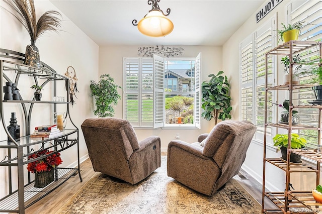 19780 W 57th Ln, Golden, CO 80403 - living area with healthy amount of natural light, baseboards, and wood finished floors