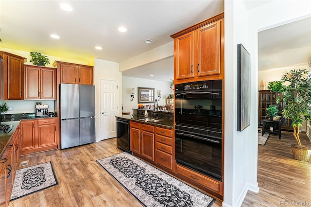 19780 W 57th Ln, Golden, CO 80403 - kitchen with black appliances, a sink, light wood-style floors, brown cabinetry, and recessed lighting