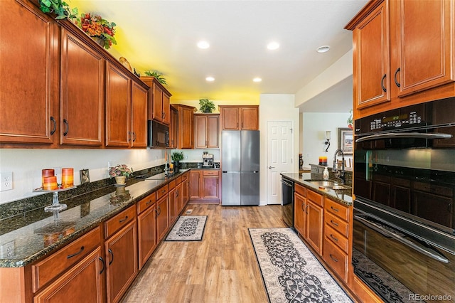 19780 W 57th Ln, Golden, CO 80403 - kitchen featuring black appliances, a sink, light wood-style floors, dark stone counters, and recessed lighting