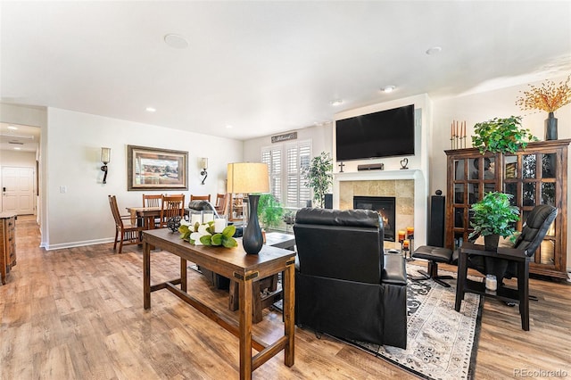 19780 W 57th Ln, Golden, CO 80403 - living room with light wood finished floors, a fireplace, baseboards, and recessed lighting