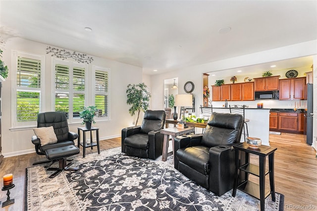 19780 W 57th Ln, Golden, CO 80403 - living room featuring plenty of natural light, light wood-type flooring, baseboards, and recessed lighting