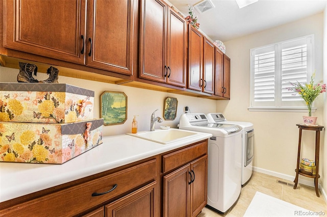 19780 W 57th Ln, Golden, CO 80403 - laundry area featuring independent washer and dryer, cabinet space, baseboards, and light tile patterned flooring