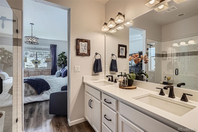 full bath featuring visible vents, a shower stall, a sink, and ensuite bathroom