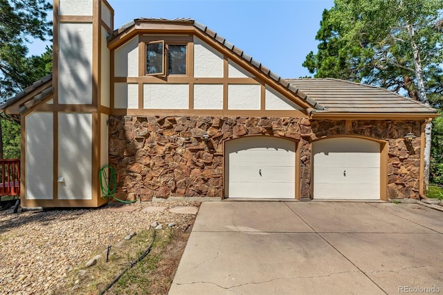 9420 Mcgill Ct, Parker, CO 80134 - view of front of home with stone siding, a tiled roof, concrete driveway, and stucco siding