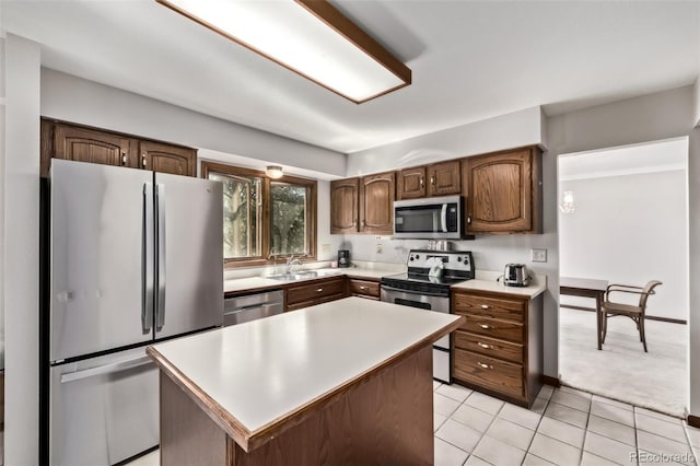9420 Mcgill Ct, Parker, CO 80134 - kitchen featuring appliances with stainless steel finishes, light countertops, light carpet, a kitchen island, and light tile patterned floors
