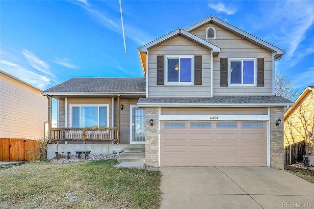 view of front of house featuring a garage and a front lawn