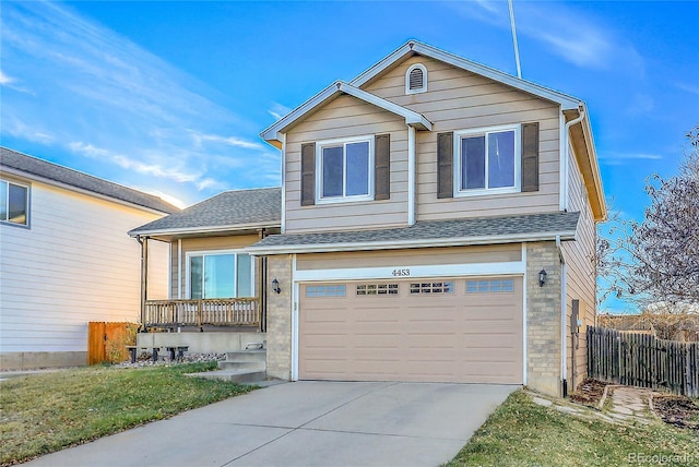 view of front of property featuring a garage and a front lawn