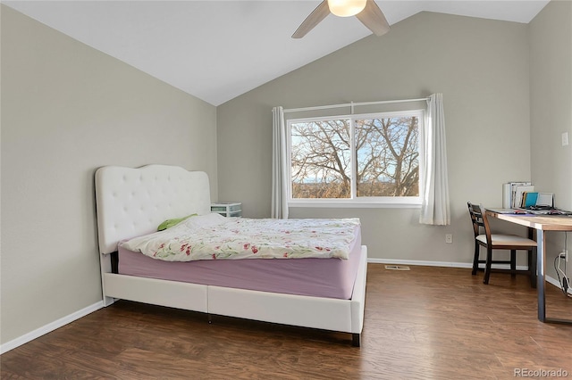 bedroom featuring dark hardwood / wood-style floors, ceiling fan, and vaulted ceiling