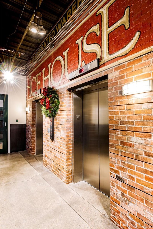 interior space with brick wall and elevator