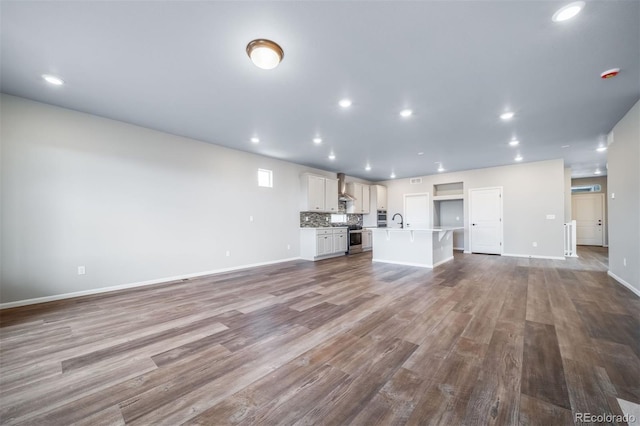 4947 N Quatar St, Aurora, CO 80019 - unfurnished living room with dark wood-style flooring and recessed lighting