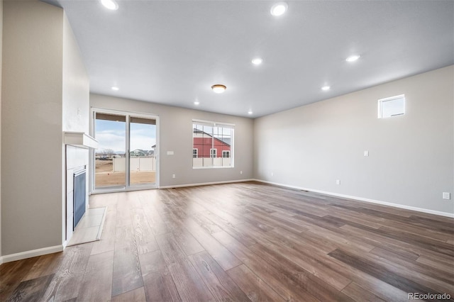 4947 N Quatar St, Aurora, CO 80019 - unfurnished living room featuring wood finished floors, a fireplace, and recessed lighting