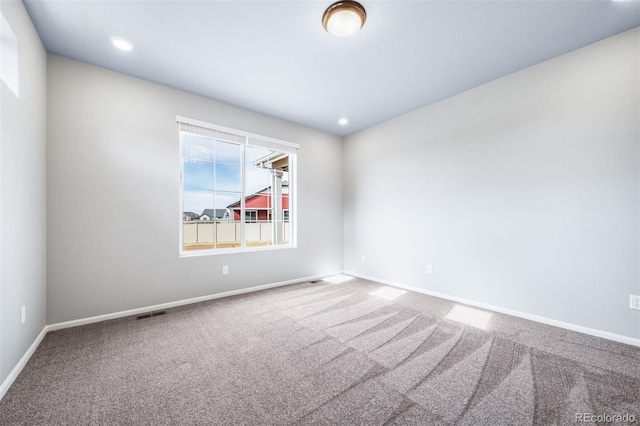 4947 N Quatar St, Aurora, CO 80019 - carpeted spare room featuring baseboards and recessed lighting