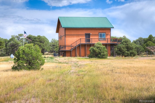 back of property featuring a deck