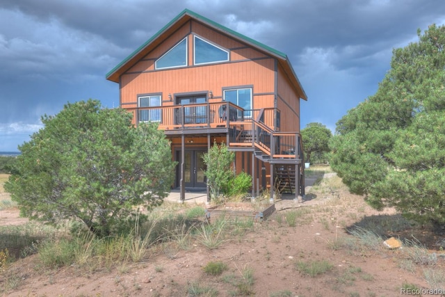 back of house with a wooden deck