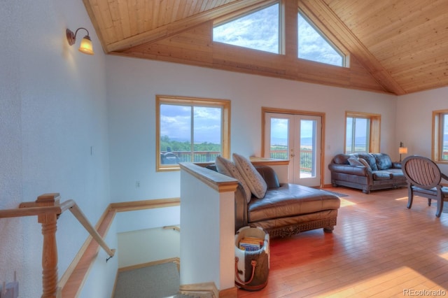 living room featuring hardwood / wood-style floors, wood ceiling, high vaulted ceiling, and french doors