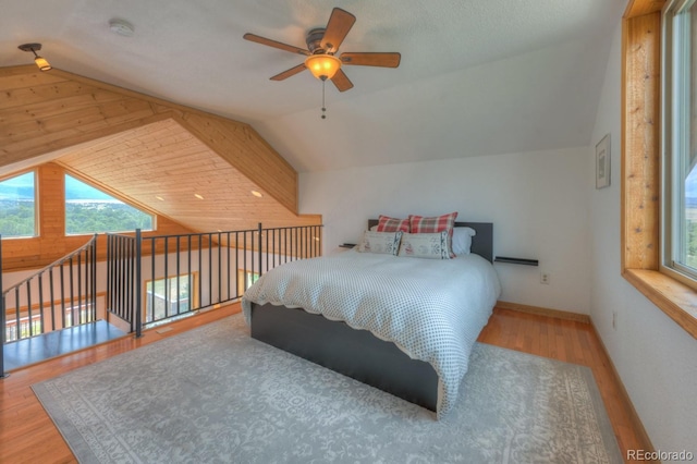 bedroom with hardwood / wood-style floors, ceiling fan, and lofted ceiling