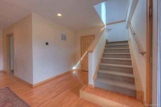 stairway with wood-type flooring