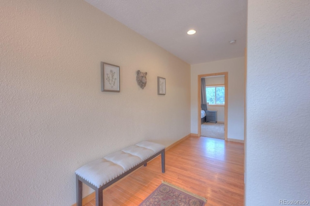 corridor with light hardwood / wood-style floors