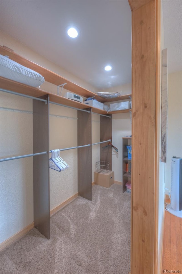 spacious closet with carpet flooring