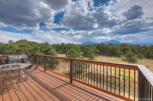 wooden deck with a mountain view