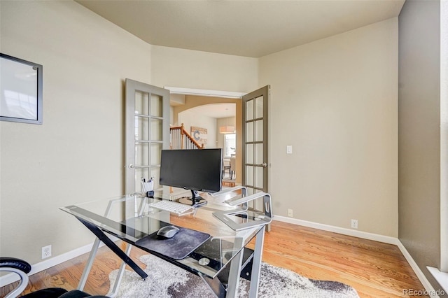 home office featuring french doors and wood-type flooring