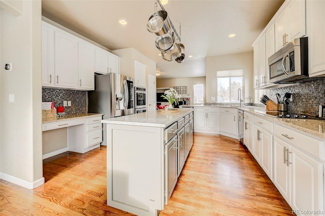 kitchen with a center island, white cabinetry, and appliances with stainless steel finishes