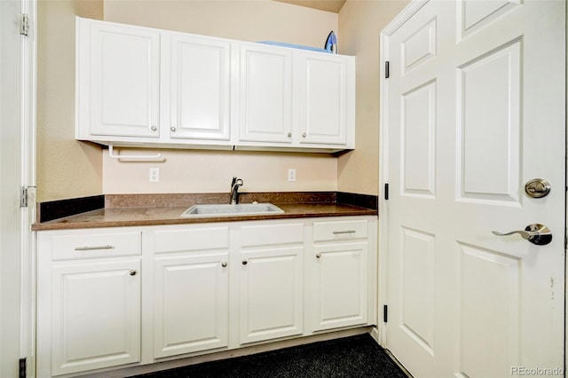 kitchen featuring white cabinets and sink