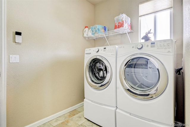 washroom featuring washing machine and dryer and light tile patterned floors