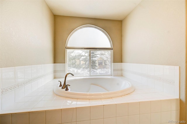 bathroom featuring tiled tub