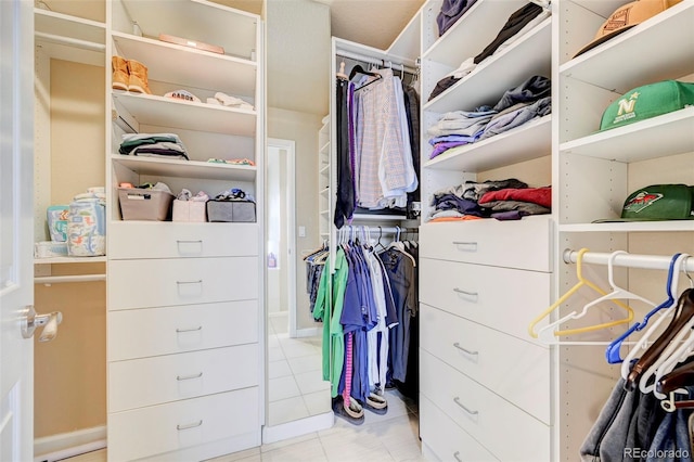 walk in closet with light tile patterned floors