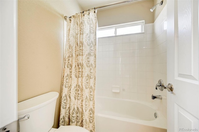 bathroom featuring shower / bath combo and toilet