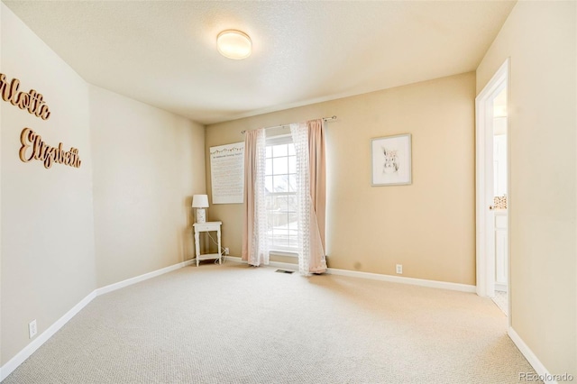 empty room featuring light colored carpet