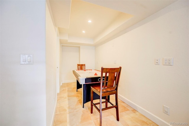 dining area with a tray ceiling