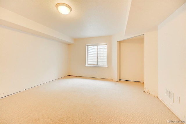 unfurnished room featuring light carpet