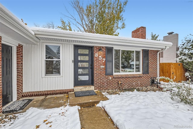 view of snow covered property entrance