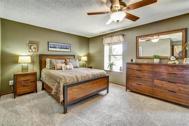 bedroom featuring carpet, baseboards, a textured ceiling, and ceiling fan