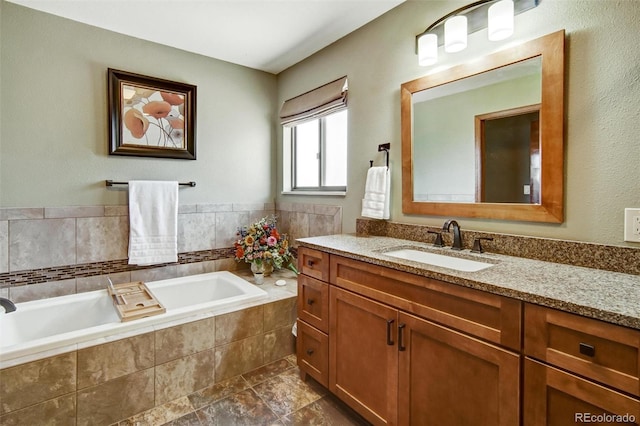 bathroom with a bath and vanity