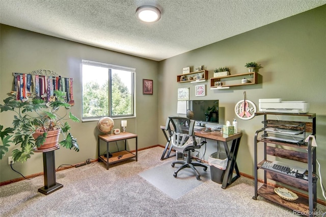 office space with carpet floors, a textured ceiling, and baseboards