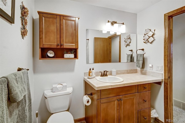 bathroom featuring toilet and vanity