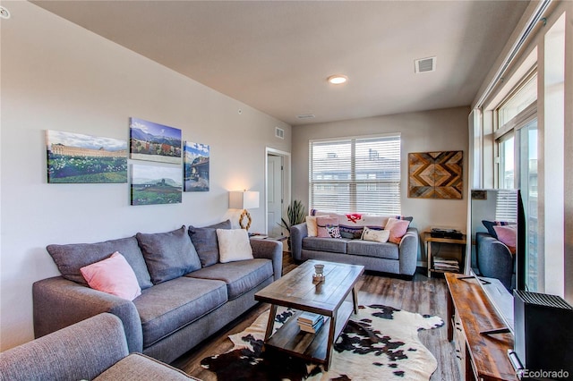 155 S Monaco Street Parkway Unit 311, Denver, CO 80224 - living area with wood finished floors and visible vents