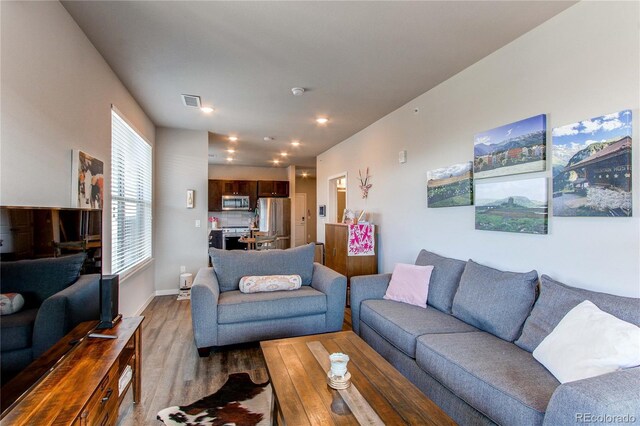 155 S Monaco Street Parkway Unit 311, Denver, CO 80224 - living room with recessed lighting, visible vents, baseboards, and wood finished floors