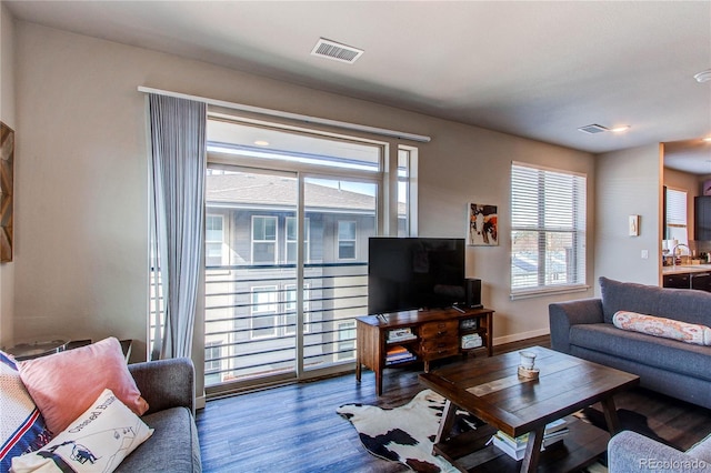 155 S Monaco Street Parkway Unit 311, Denver, CO 80224 - living room featuring baseboards, visible vents, and wood finished floors
