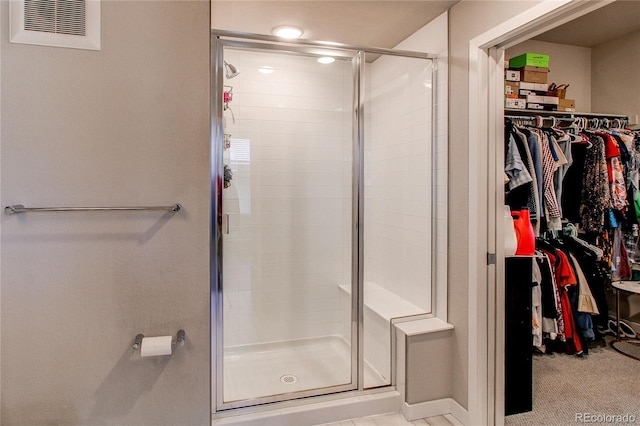 155 S Monaco Street Parkway Unit 311, Denver, CO 80224 - bathroom featuring a stall shower, a walk in closet, and visible vents