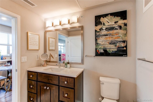 155 S Monaco Street Parkway Unit 311, Denver, CO 80224 - bathroom with toilet, vanity, and visible vents