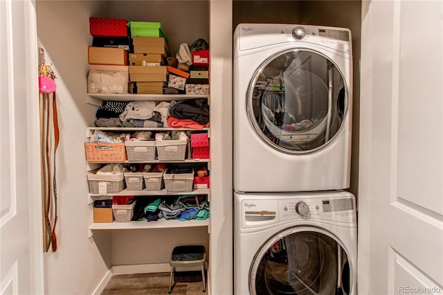 155 S Monaco Street Parkway Unit 311, Denver, CO 80224 - laundry area featuring stacked washer / drying machine, laundry area, and baseboards