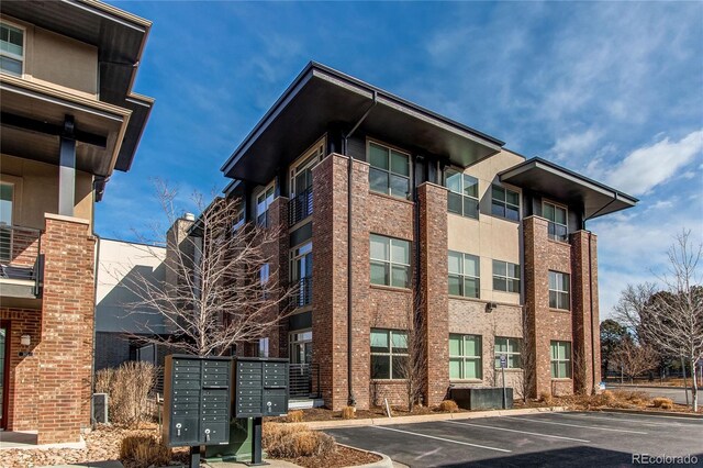 155 S Monaco Street Parkway Unit 311, Denver, CO 80224 - view of building exterior featuring uncovered parking