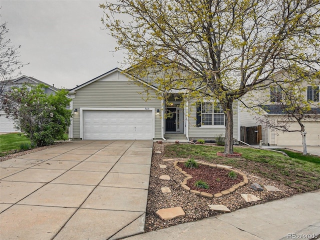 view of front of property featuring concrete driveway and a garage